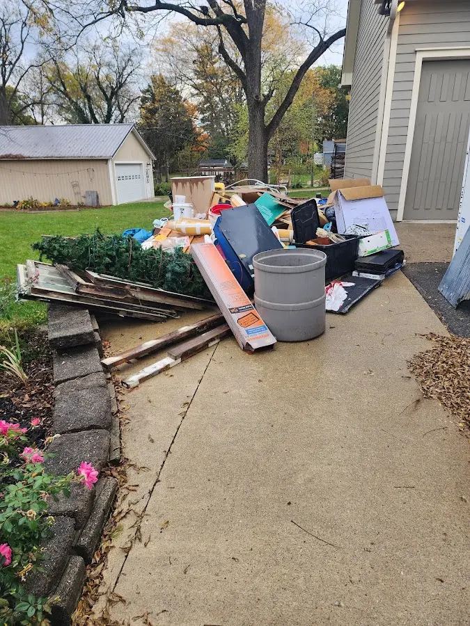Dumpster being loaded with debris for Roofing Dumpster Rental in Battle Creek